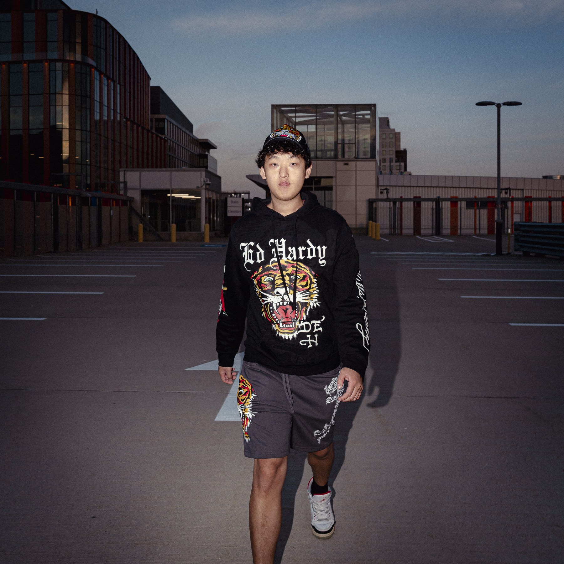 Portrait in a parking lot at dusk.